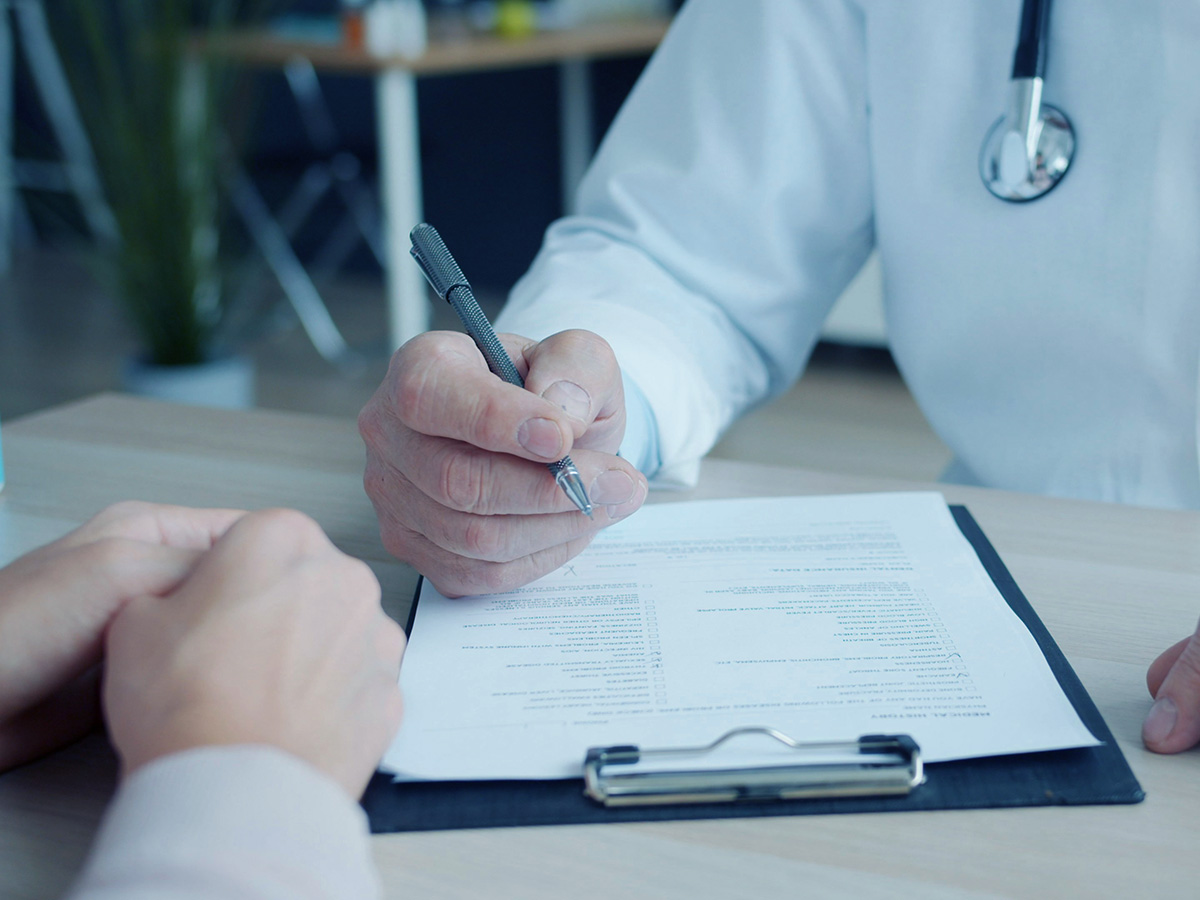 Clinician reviewing medical paperwork with a patient — featured article cover